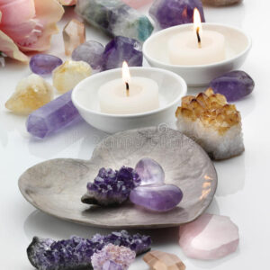 healing-crystals-amethyst-rose-citrine-quartz-scented-candles-white-reflective-background-45891319